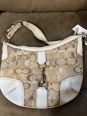 Coach Beige Signature Canvas Hobo Bag with White Leather Trim needs cleaning